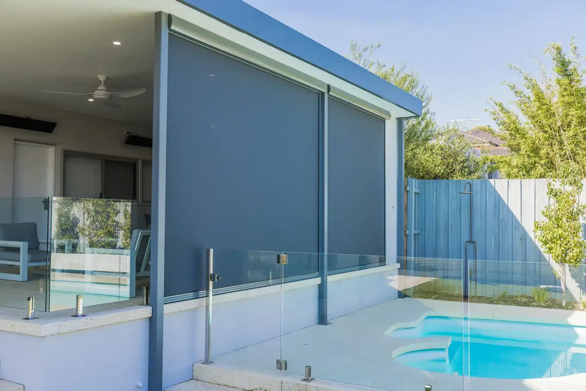 Grey outdoor blinds enclosing a poolside alfresco at a Perth home