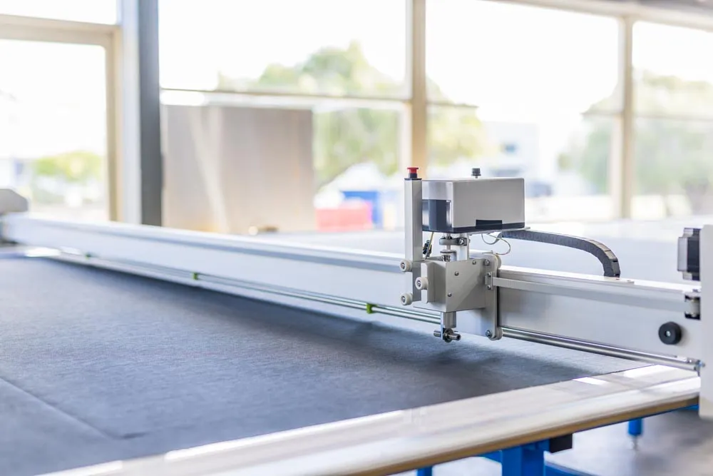 CNC cutting head trimming outdoor blind fabric to size in the Wangara factory