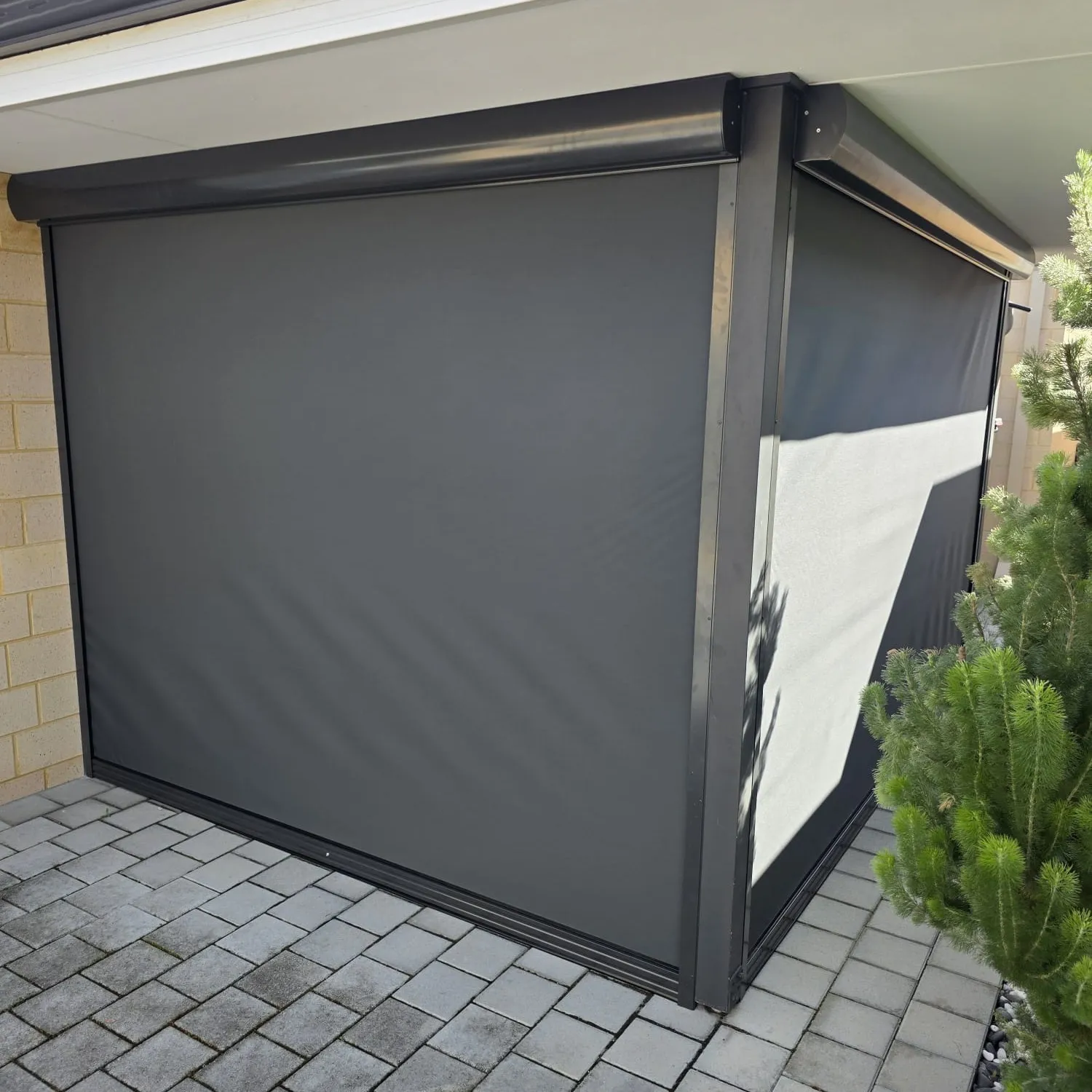 Charcoal Slidetrack blinds wrapping a paved alfresco corner