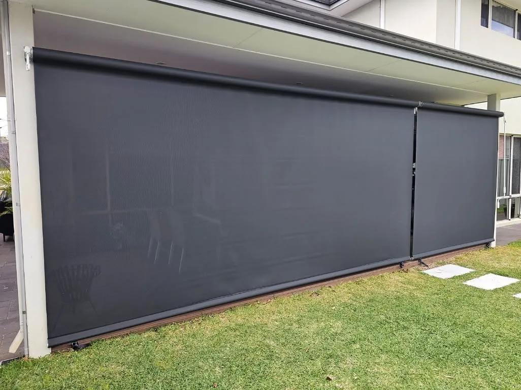 Charcoal Slidetrack blinds lowered along a patio beside the lawn
